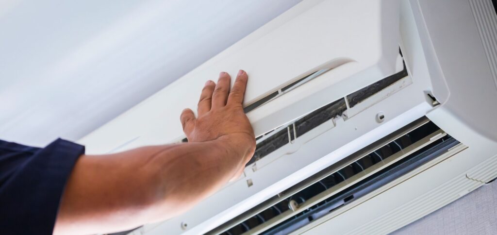 Person maintaining air conditioning unit