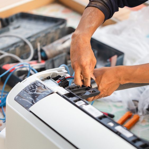 Technician repairing air conditioner components